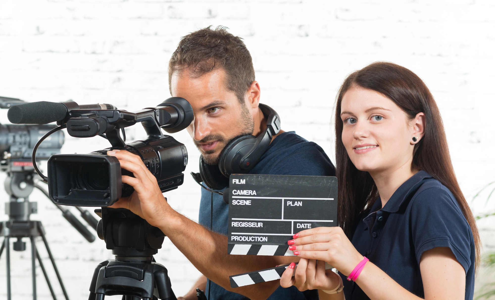 A cameraman and a young woman with a movie camera